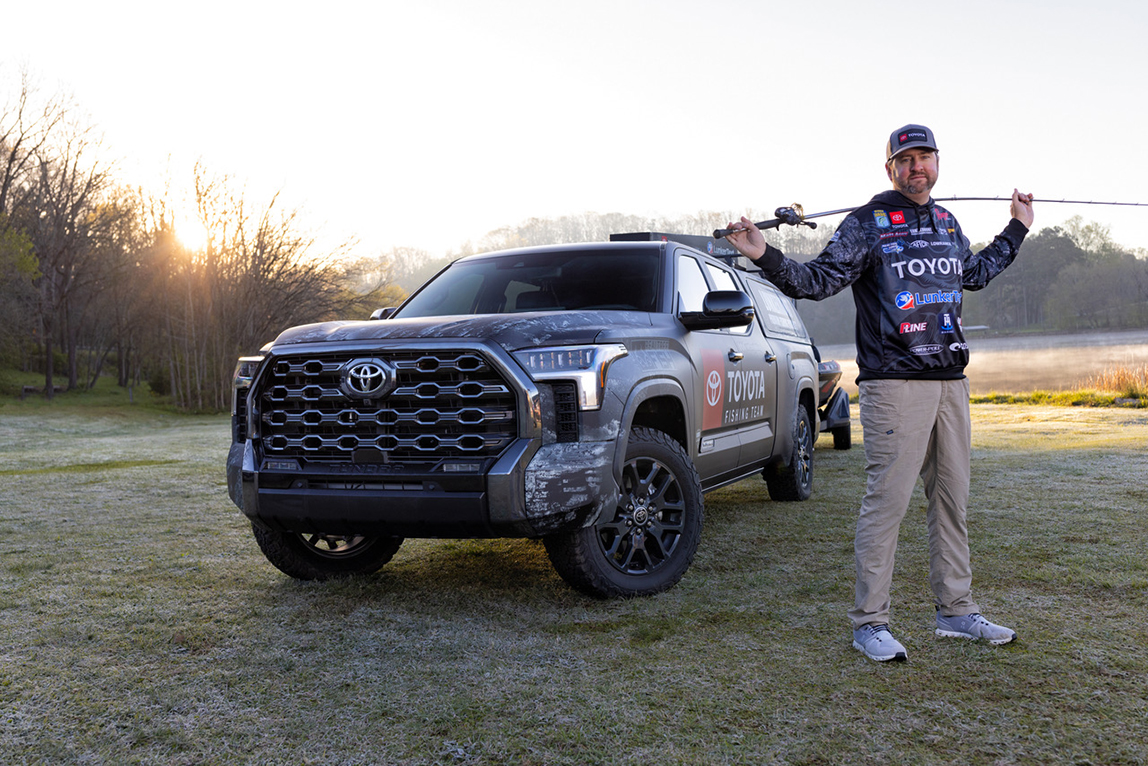 A #TeamToyota angler beside a Toyota Tundra at the water's edge